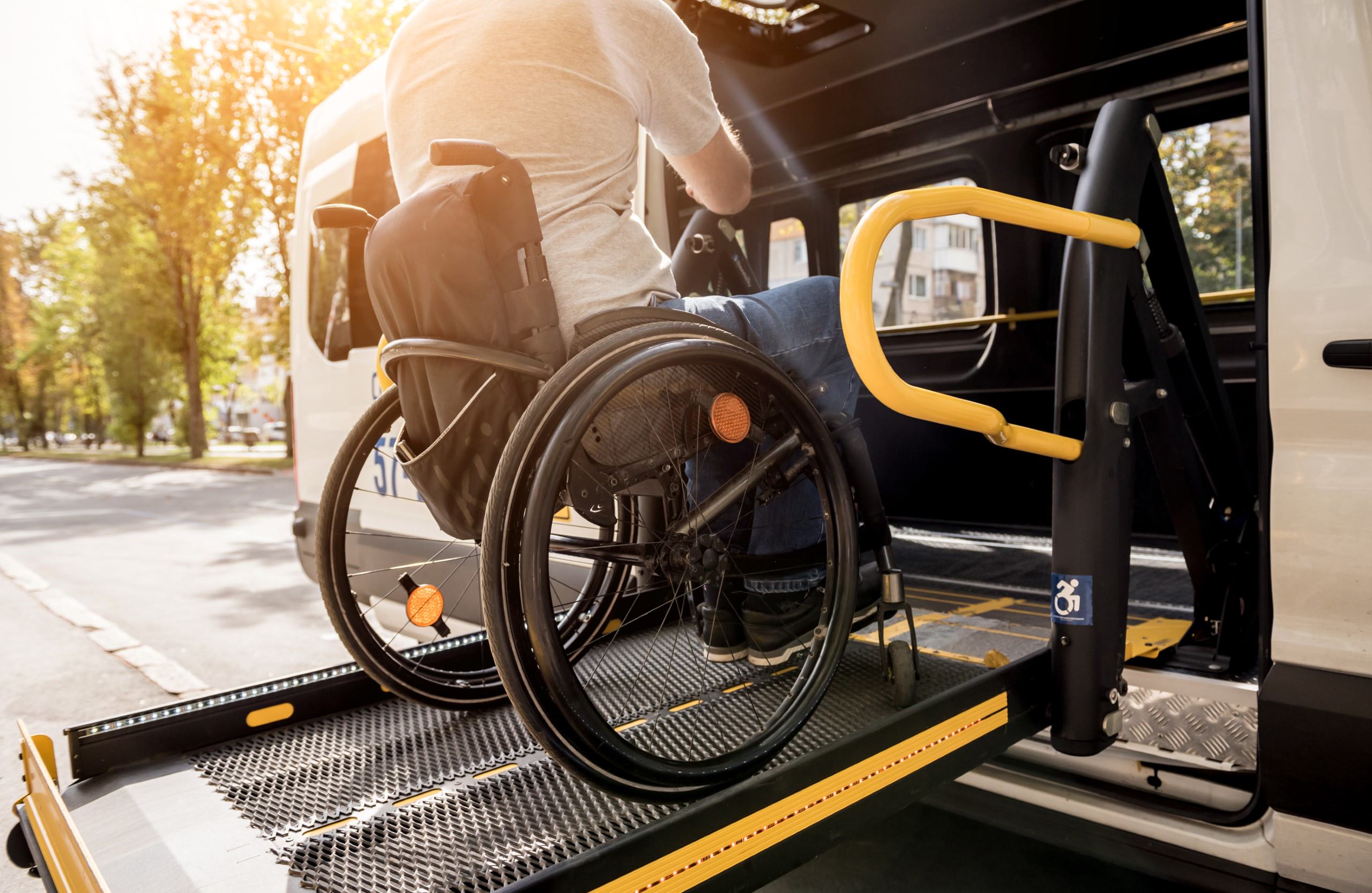 A man in a wheelchair using a vehicle lift