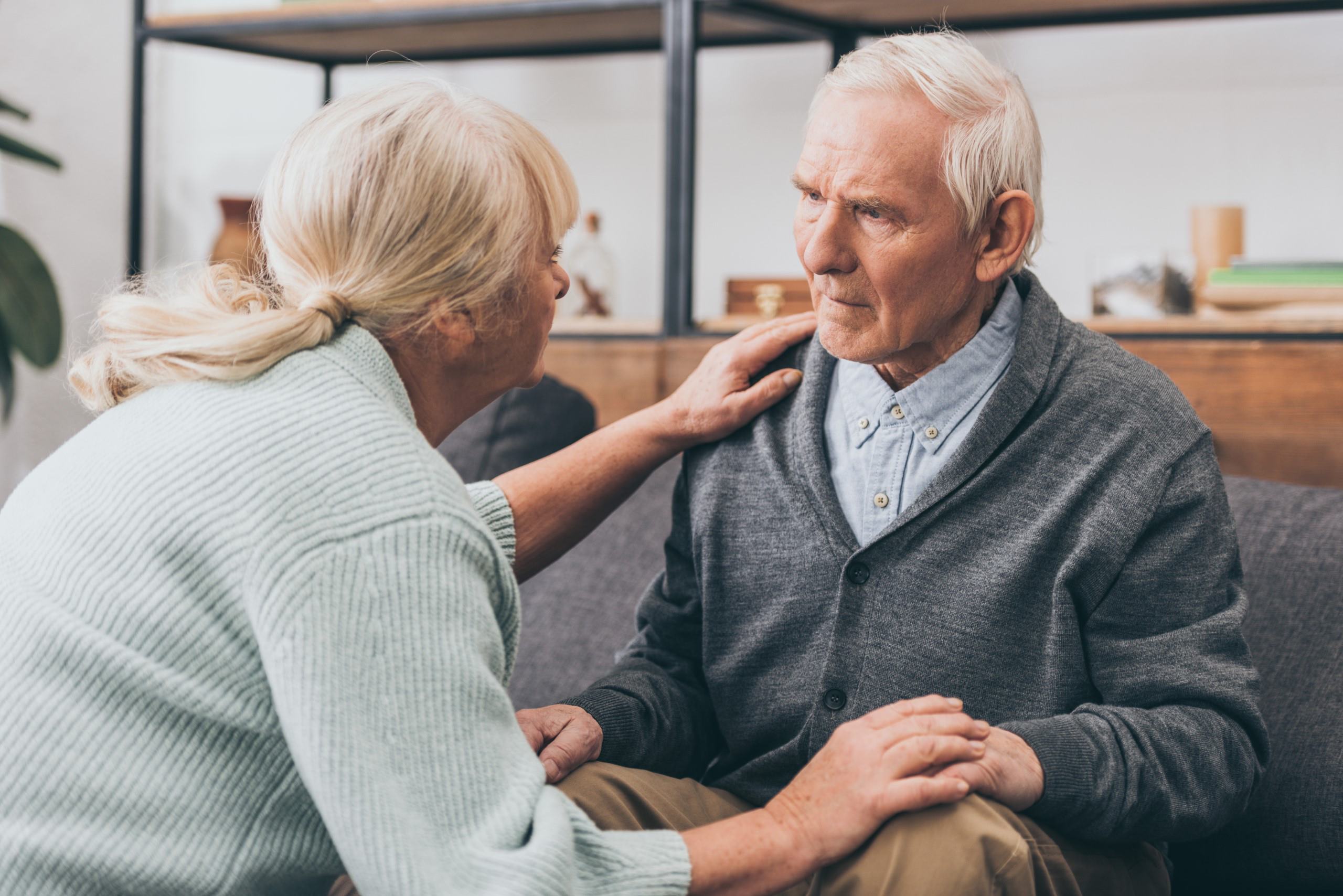 A woman comforting a man who has dementia
